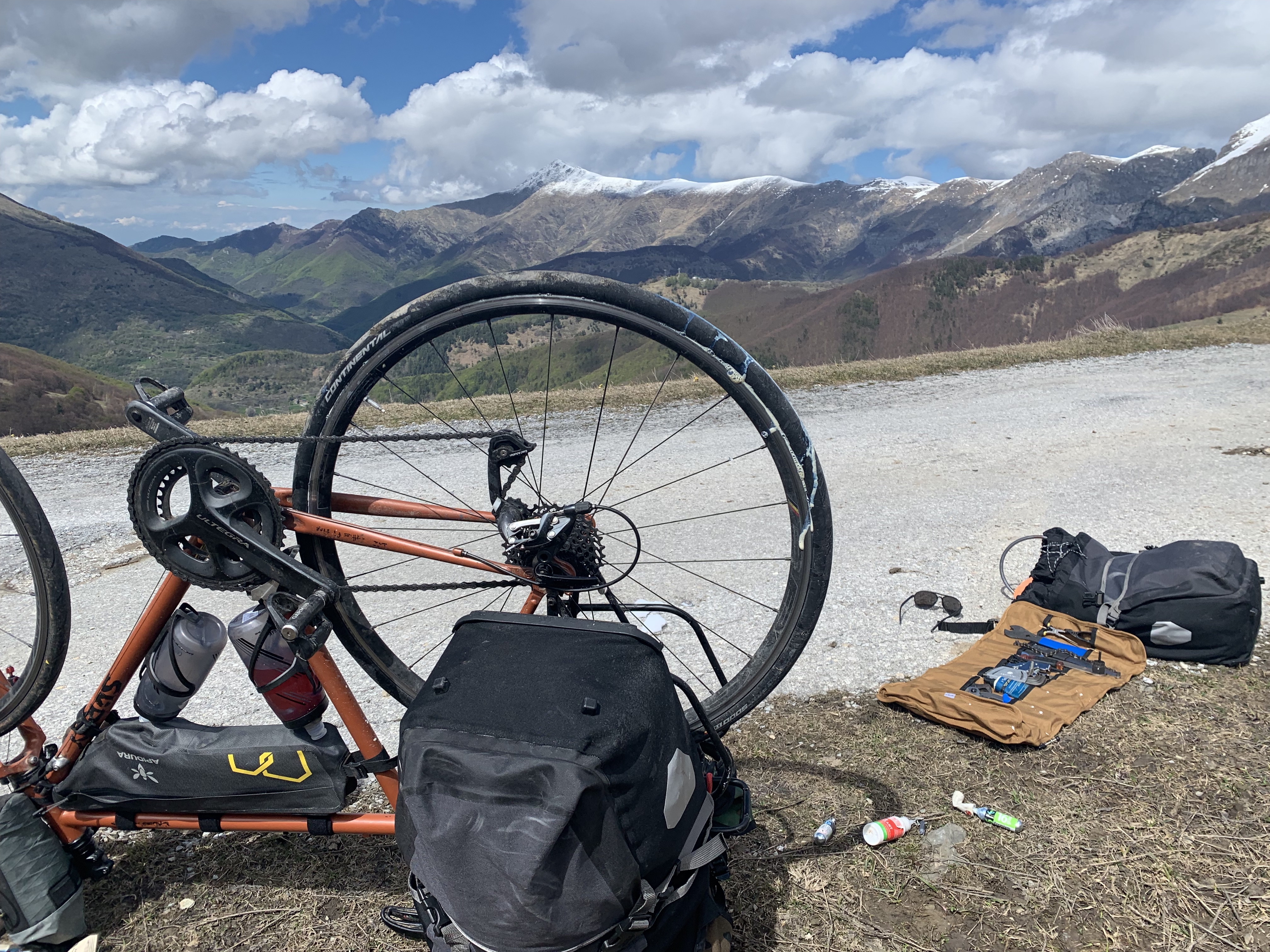 Dealing with tubeless tyre failure, replacing sealant and reseating a tyre, just after crossing from France to Italy still up in very nippy mountains.