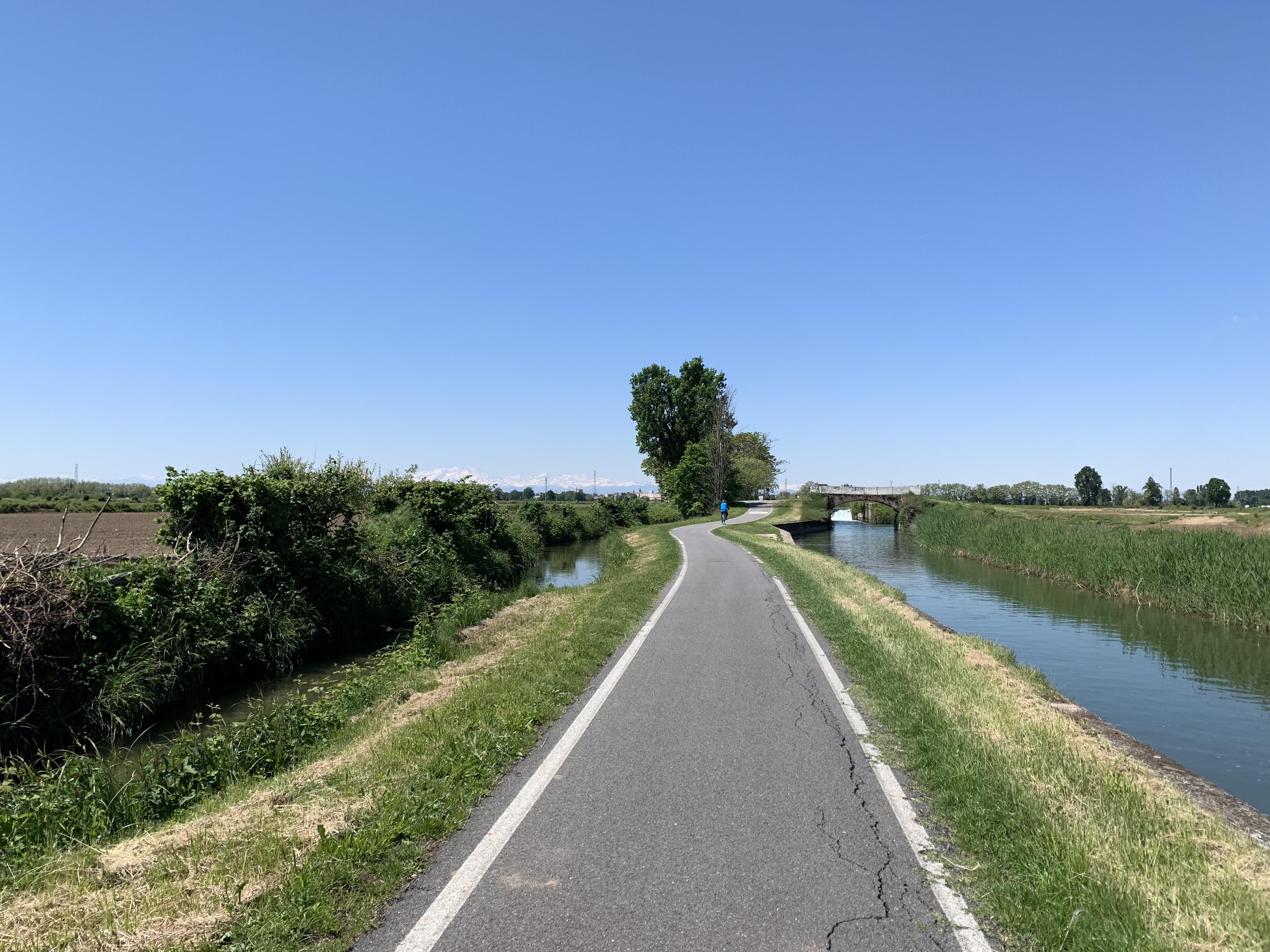 Amazing canal-side bike paths with Alps in the back